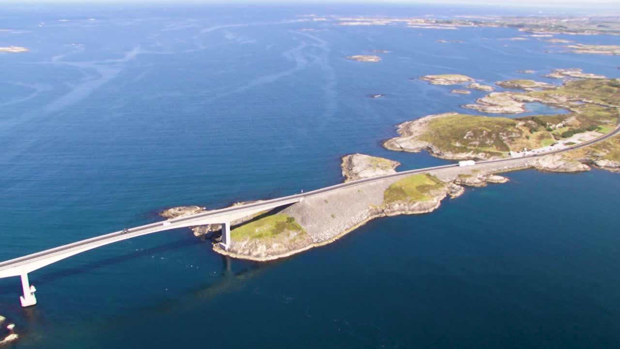 Scenic drone view of coastal road connecting small islands on sunny day