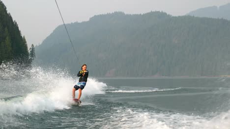 Vorderansicht-Eines-Kaukasischen-Jungen-Mannes,-Der-Tricks-Auf-Dem-Wakeboard-Im-Stadtfluss-Macht,-4k