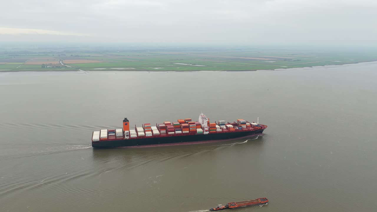 Aerial shot of cargo vessel cruising along the Elbe in northern Germany