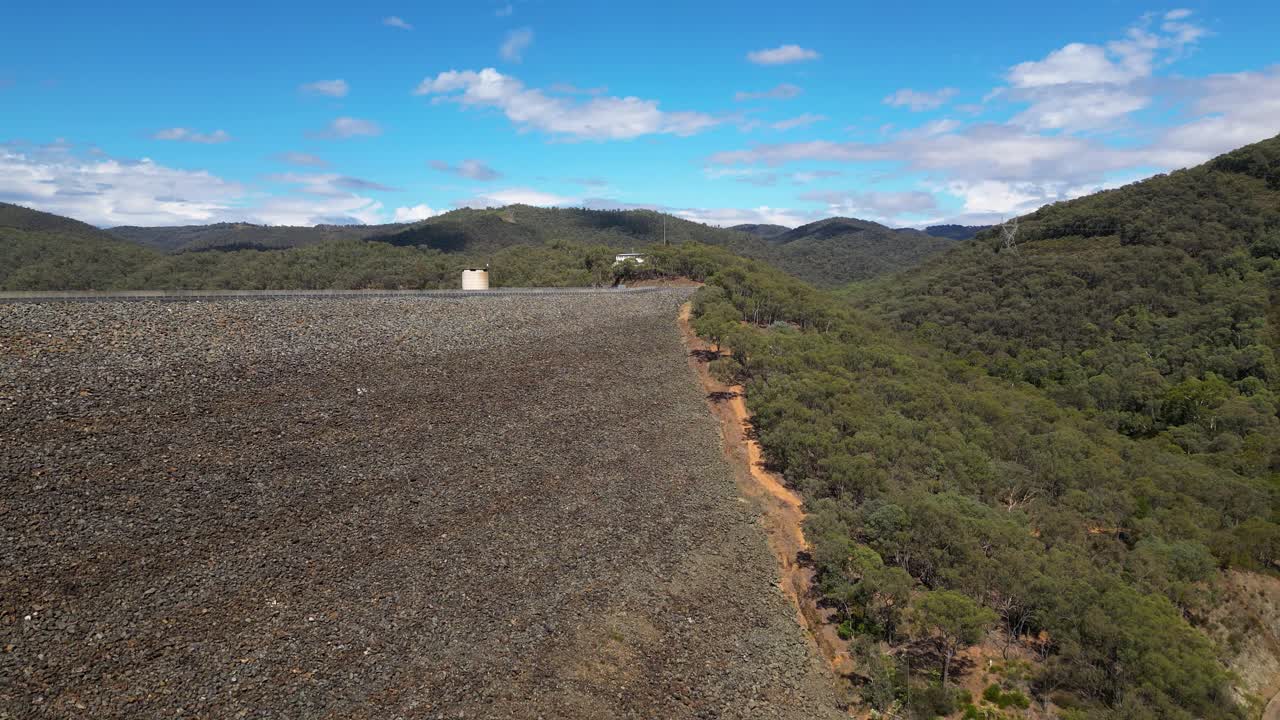 Rising aerial views over the Blowering Dam and Reservoir, New South Wales alpine region.