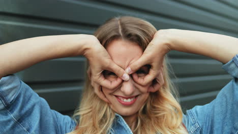 portrait of blonde cheerful young woman posing funny for the camera