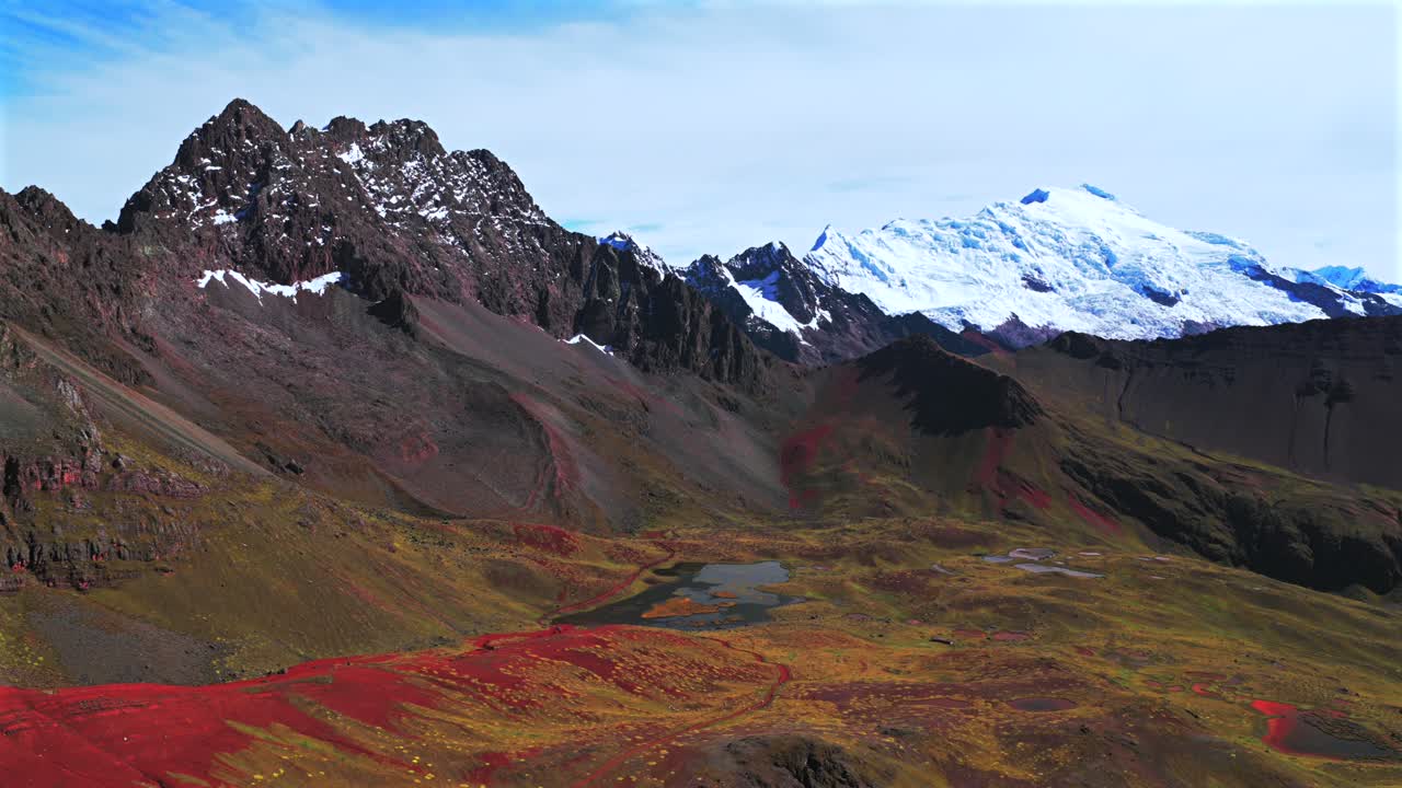 Peruvian Andes valley Ausangate Glacier Rainbow Mountain Vinicunca Peru Perú glacial Nevado Auzangate Vilcanota Cusco Region morning blue sky clouds Hatun Ritty rainy season forward pan up motion