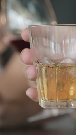a glass of whiskey with ice