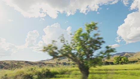 Side-view-from-the-bus-or-car-on-the-beautiful-scenery-with-hills-and-forest-on-sunny-day