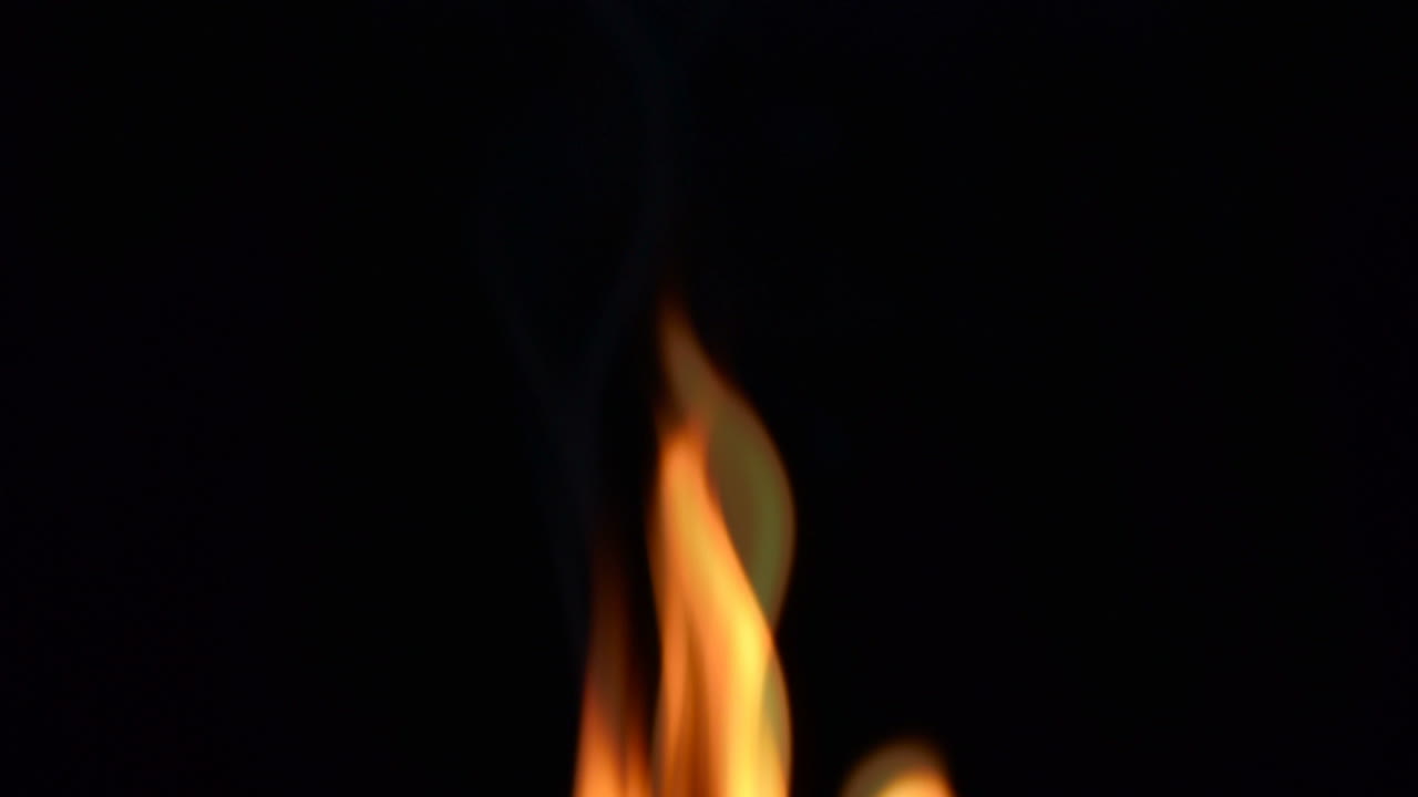 Slow Motion. Fire on a black background. Slow Motion. Tongues of flame