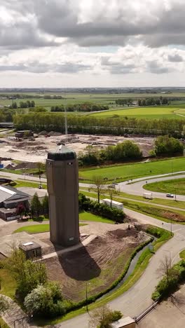construction site surrounding water tower in rural landscape