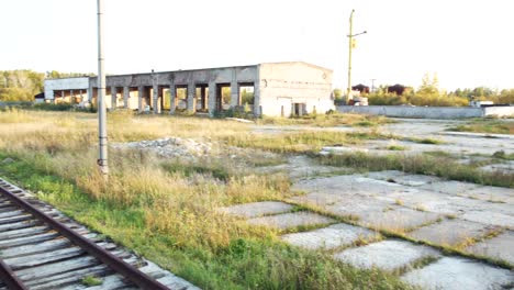 abandoned train tracks at a rusted industrial site