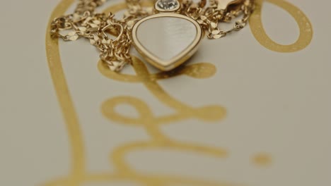 macro tilt up to a beautiful golden necklace with a small diamond in the pendant