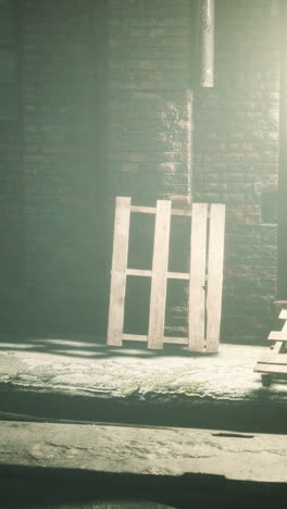 old wooden pallet leaning against a brick wall in a foggy abandoned warehouse