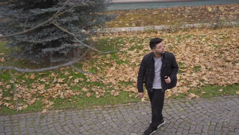 the man walking in the city in the autumn season.