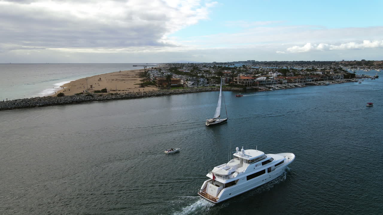 vista aérea alrededor de un yate y velero en la playa de newport, en los ángeles, estados unidos