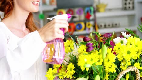 female florist watering flowers