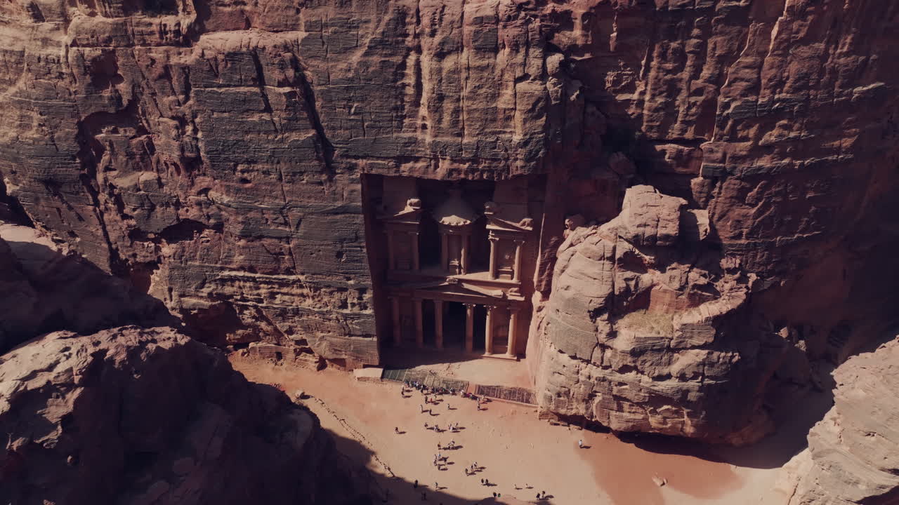 UNESCO World Heritage site The Treasury sandstone tomb facade, Petra, Establishing drone shot