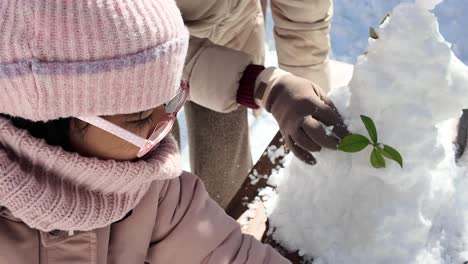 child building snowman