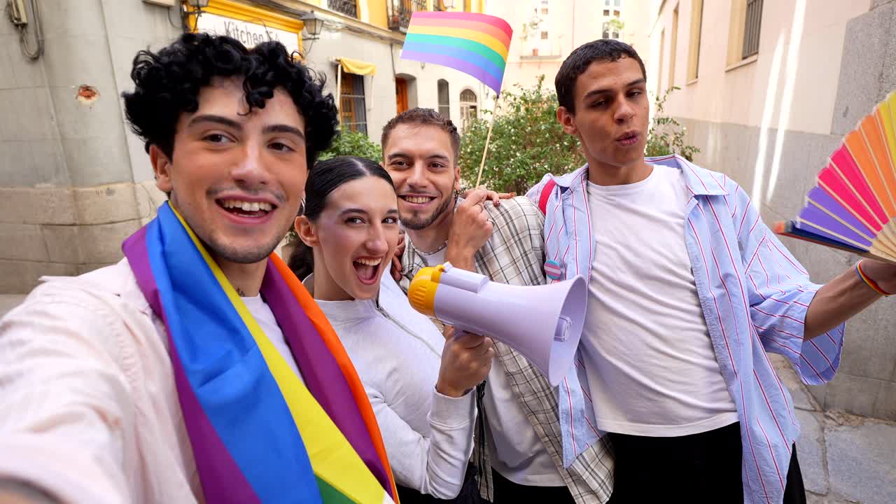 Group of young adults celebrating pride with a megaphone