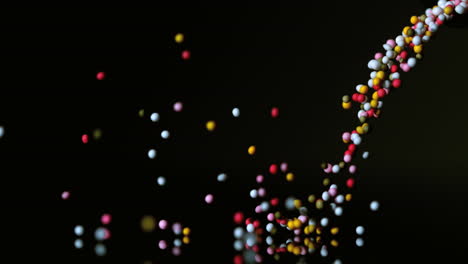 sprinkles pouring onto black surface