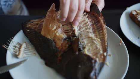 Eating-Smoked-Fish-with-Hands,-Healthy-Dinner-at-Home,-Slow-Motion