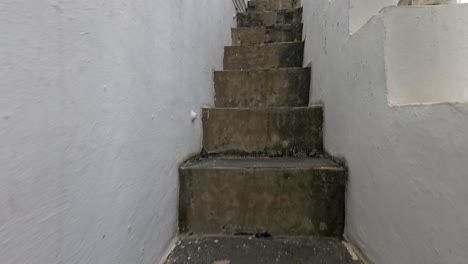 a journey up narrow stone steps leading to a temple rooftop, showcasing traditional thai architecture under natural daylight