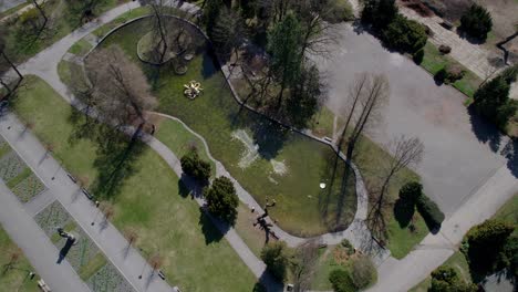 park in olomouc with a pond reflecting the spring sun on the surface