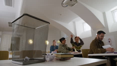 classroom with students and trash can