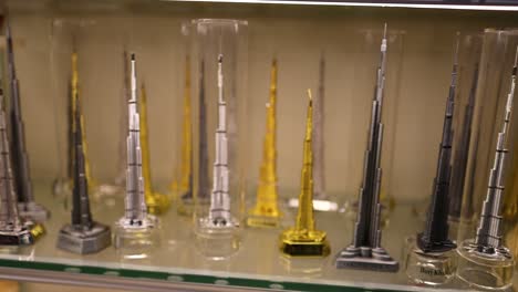 miniature burj khalifa models on display shelf