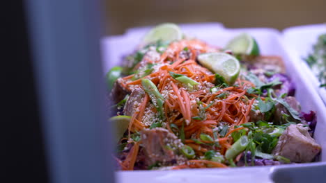 Close-up-shot-of-a-woman-adding-lime-to-a-plate-full-of-chicken-salad