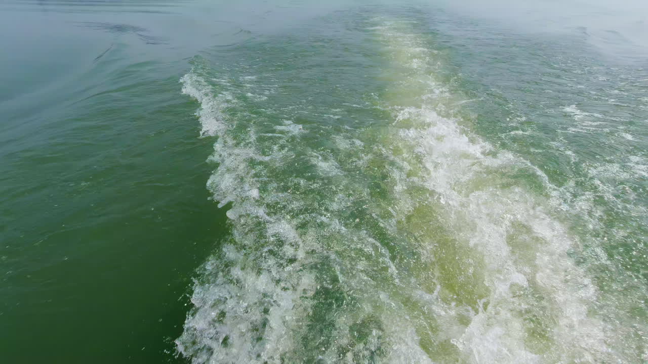 Morning boat safari on Kabini River, with a view of the water trail behind a boat