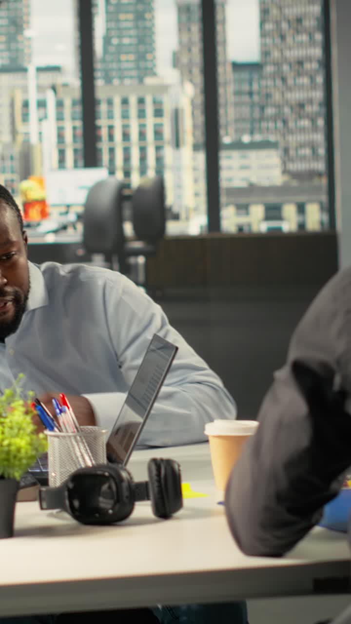 Vertical Video Diverse coworkers in meeting discuss strategy and budgeting