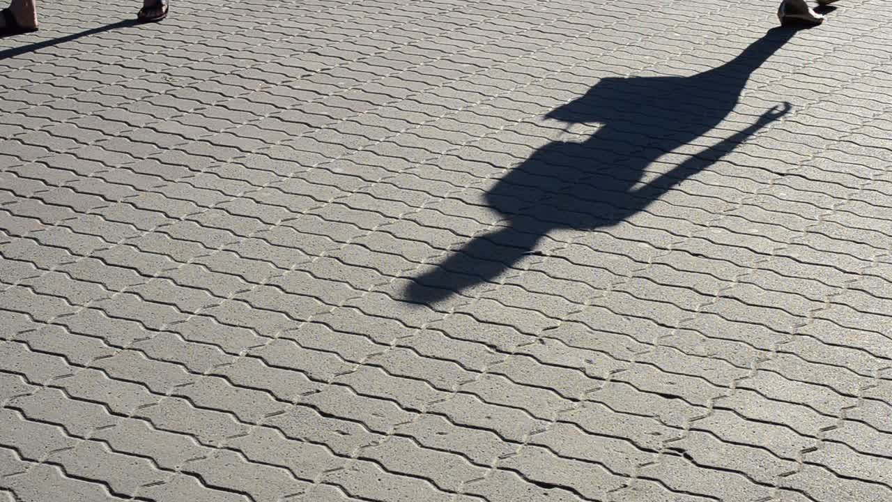 Light and shade, reflection of people in beams of the setting sun. People and shadows from them