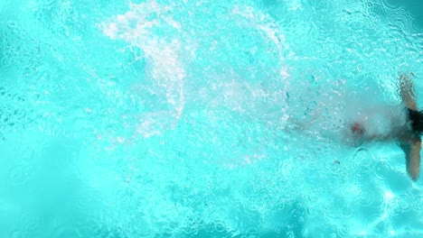 brunette diving in the swimming pool