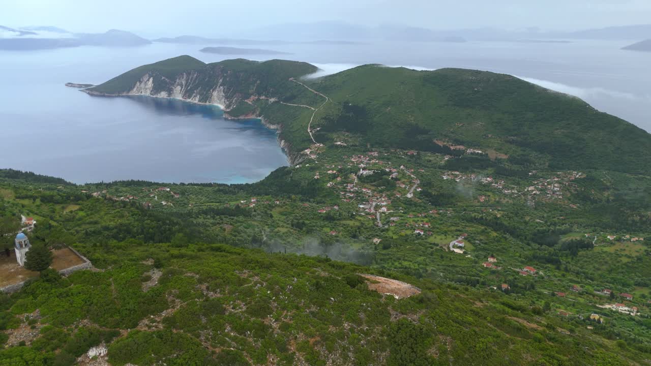 Panoramic drone view from mountain monastery in Ithaca Greece over forested hills and small traditional villages
