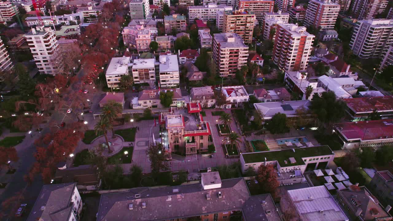 Aerial view establishing in the heart of Providencia with the Falabella Palace and residential buildings in Santiago, Chile