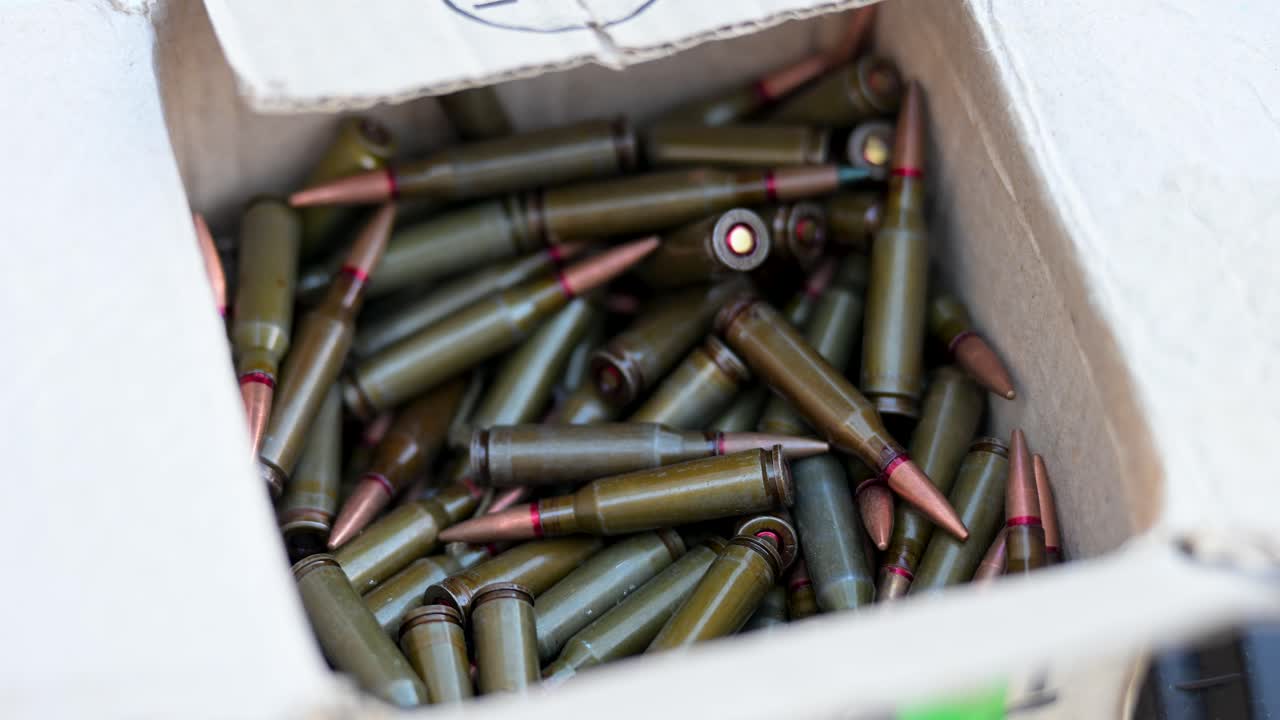 Combat preparation at a military training ground. This footage shows a close-up of a box full of rifle cartridges, highlighting the logistics and munitions supply for armed forces exercises in Ukraine