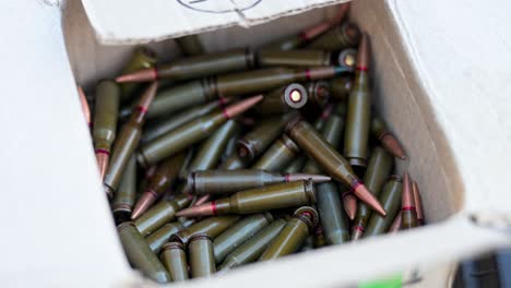 combat preparation at a military training ground. this footage shows a close-up of a box full of rifle cartridges, highlighting the logistics and munitions supply for armed forces exercises in ukraine