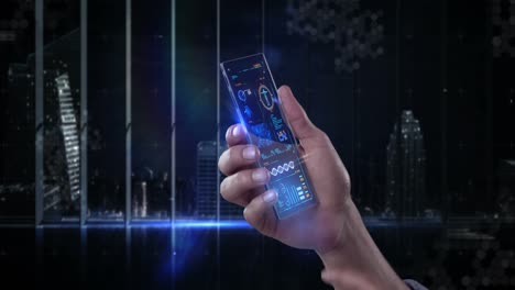 Hand-holding-futuristic-mobile-phone-against-digitally-generated-background