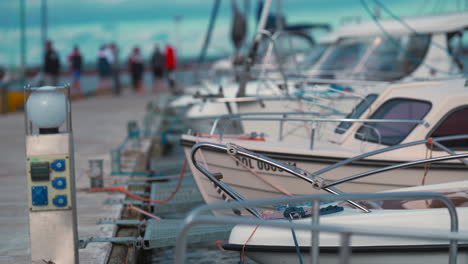 yachts moored in marina pier with blue crystal clear water