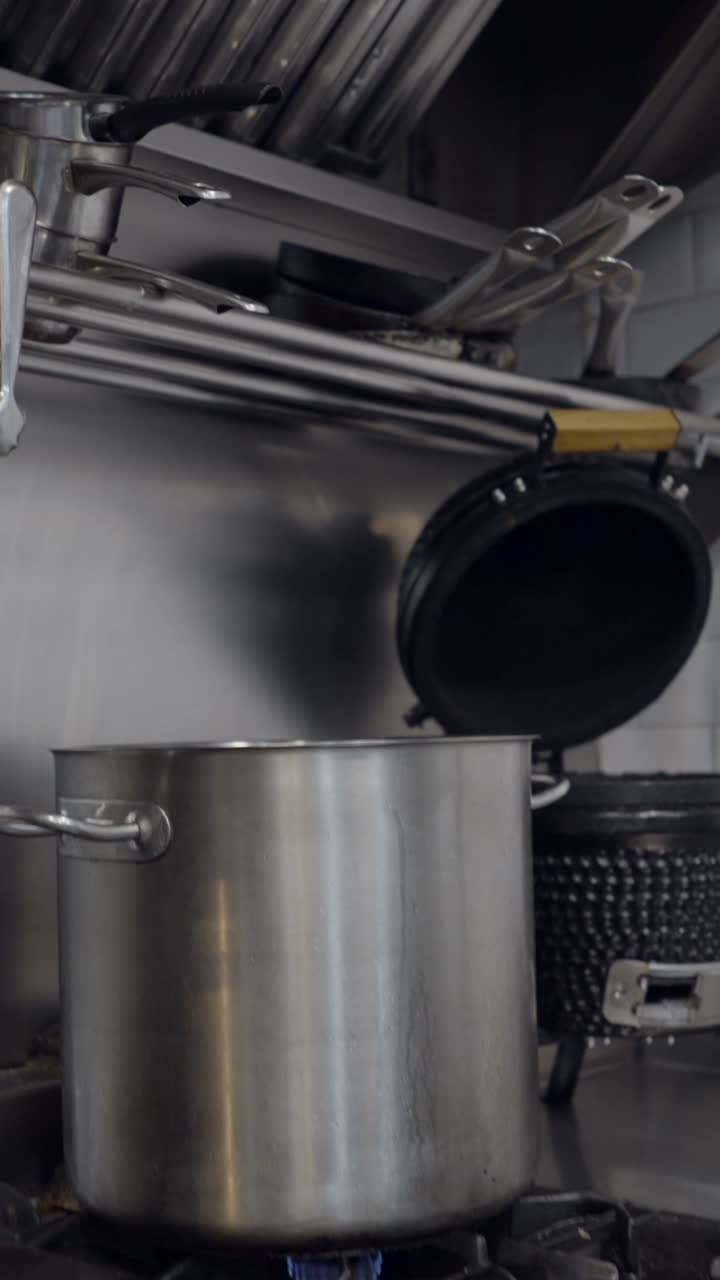 Commercial Kitchen Equipment with Stainless Steel Surfaces and Ventilation Hood