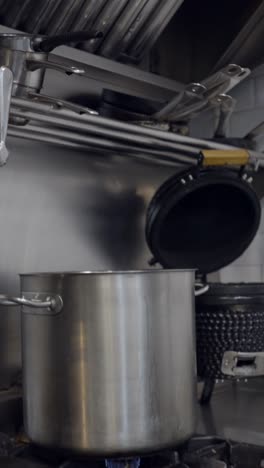 commercial kitchen equipment with stainless steel surfaces and ventilation hood