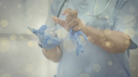 animación de manchas amarillas sobre un médico caucásico que se pone guantes.