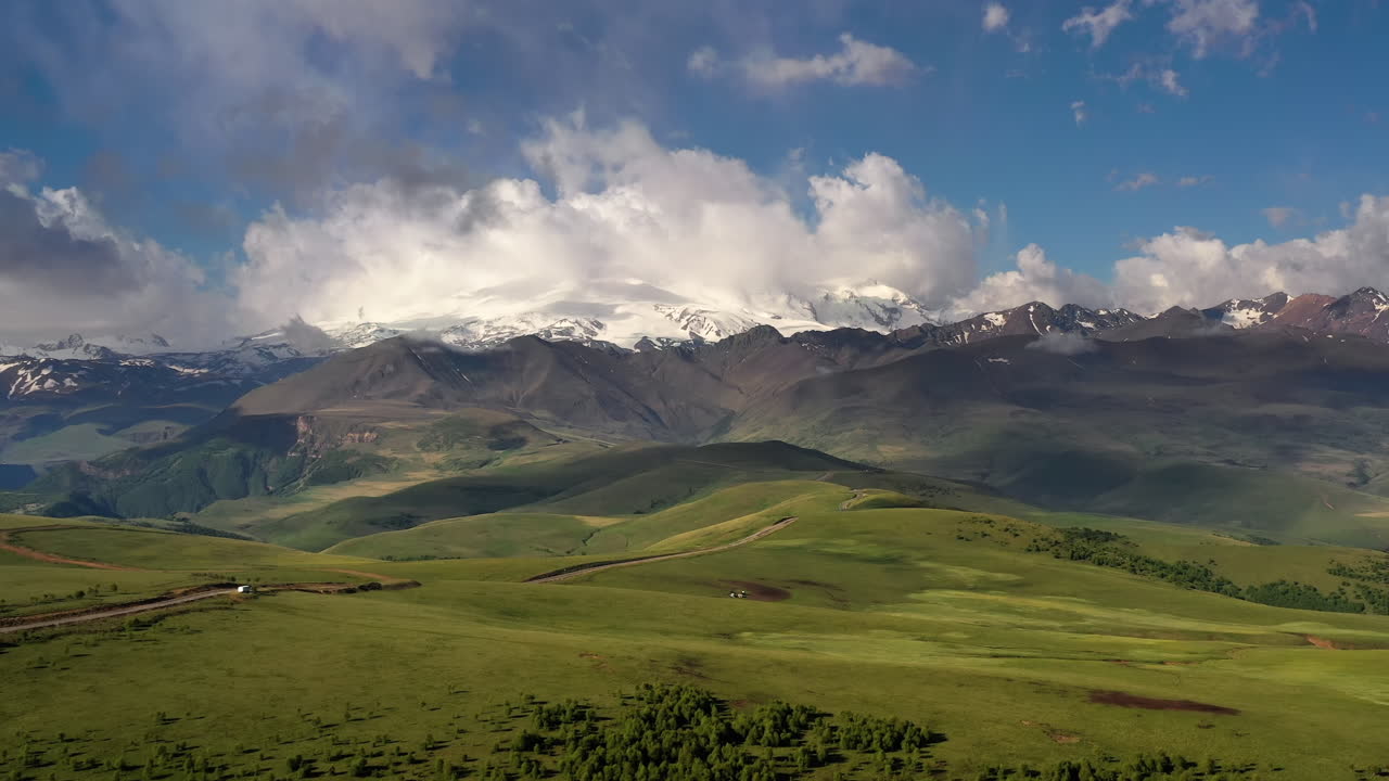Elbrus Region. Flying over a highland plateau. Beautiful landscape of nature. Mount Elbrus is visible in the background.