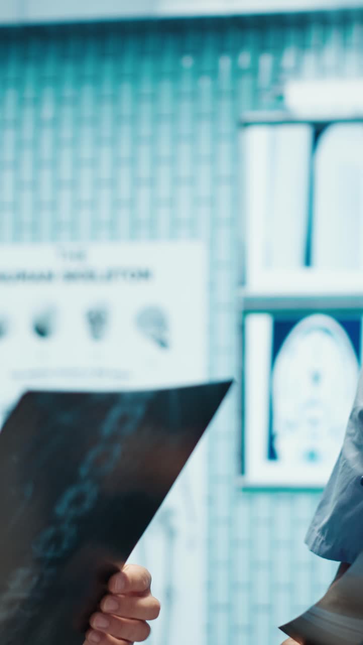 Vertical Video Physicians and radiologists analyzing x ray scans to create treatment plan