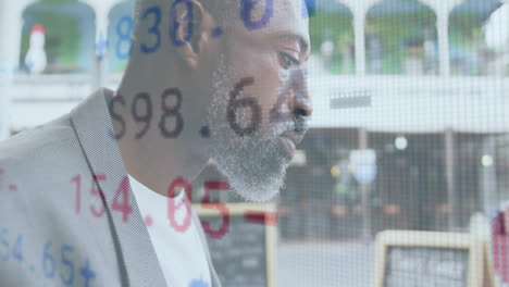 animation of financial data processing over african american man eating sandwich