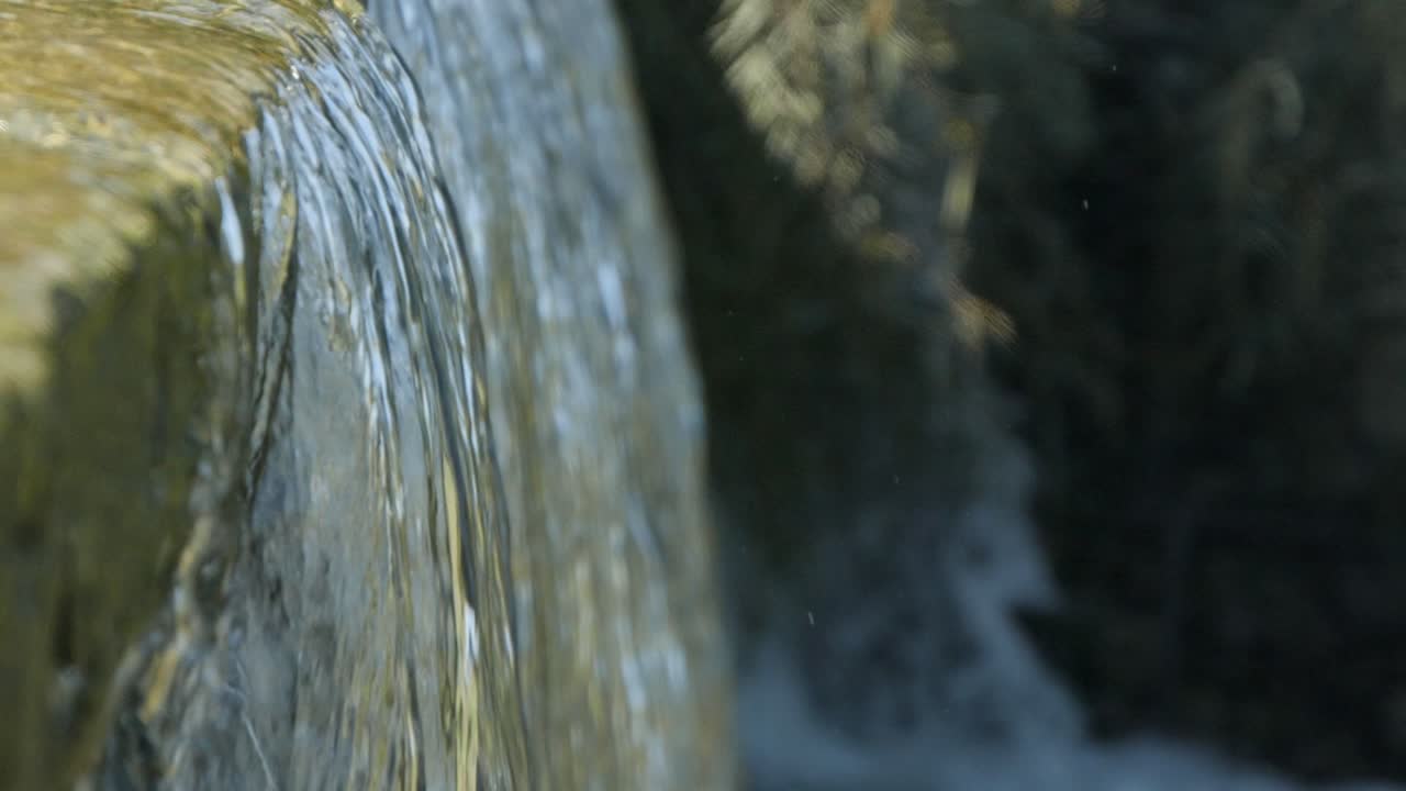 Close-up of water cascading over a rock