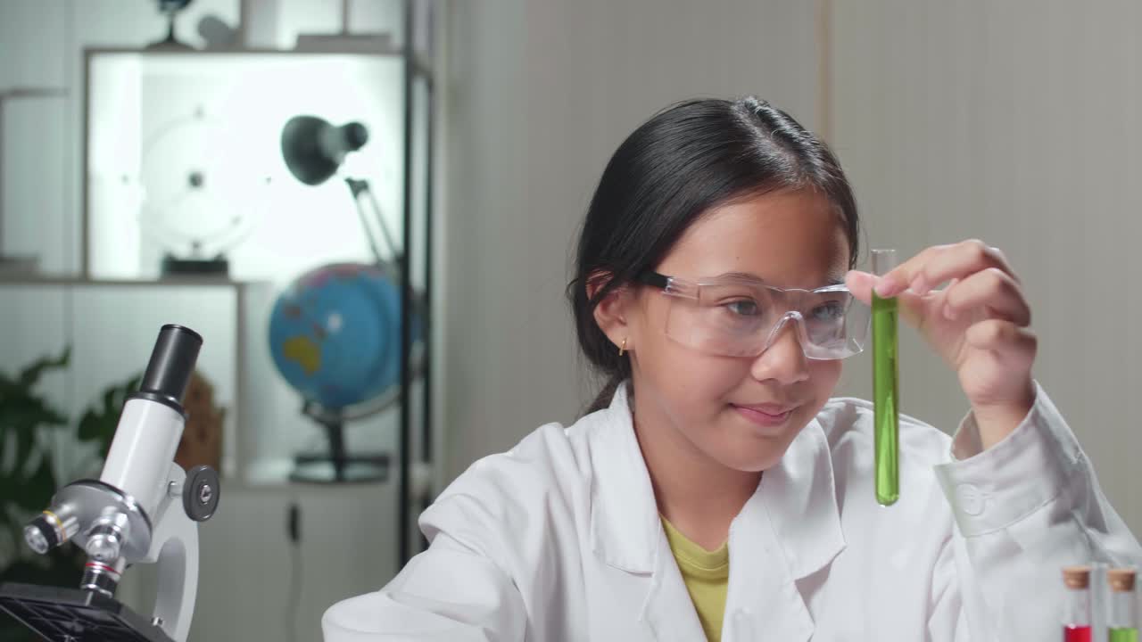 Young Scientist Girl Looking At Liquid In Test Tube