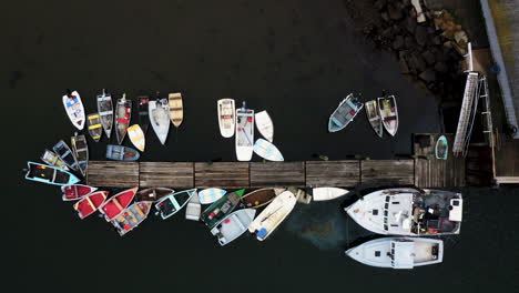 drone shot of docks with small boats and lobster fishing boat leaking oil into the ocean hd 30p