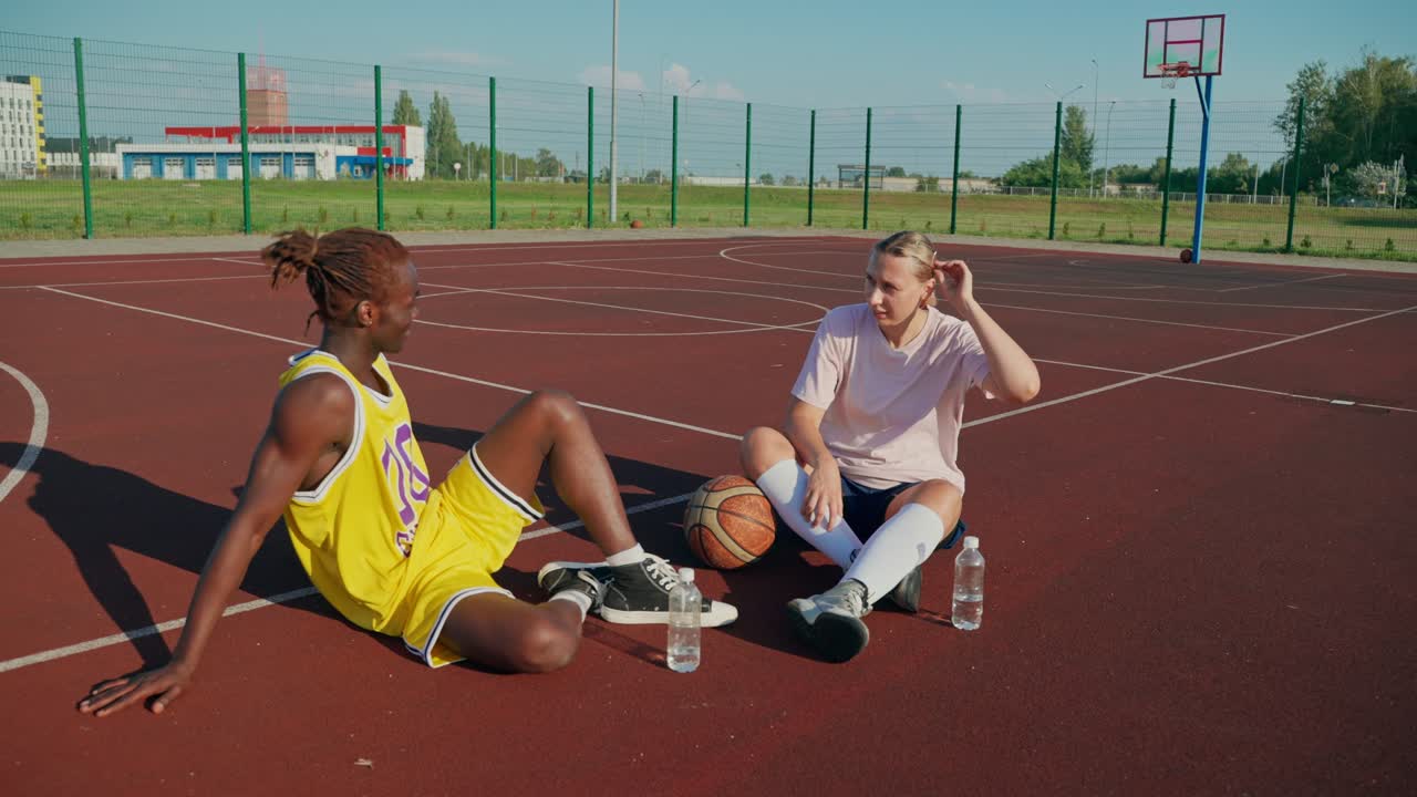 Basketball Players Resting on the Court