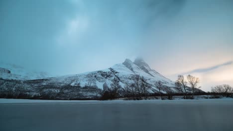 snow-covered otertinden mountain in norway, captured in a stunning timelapse shot