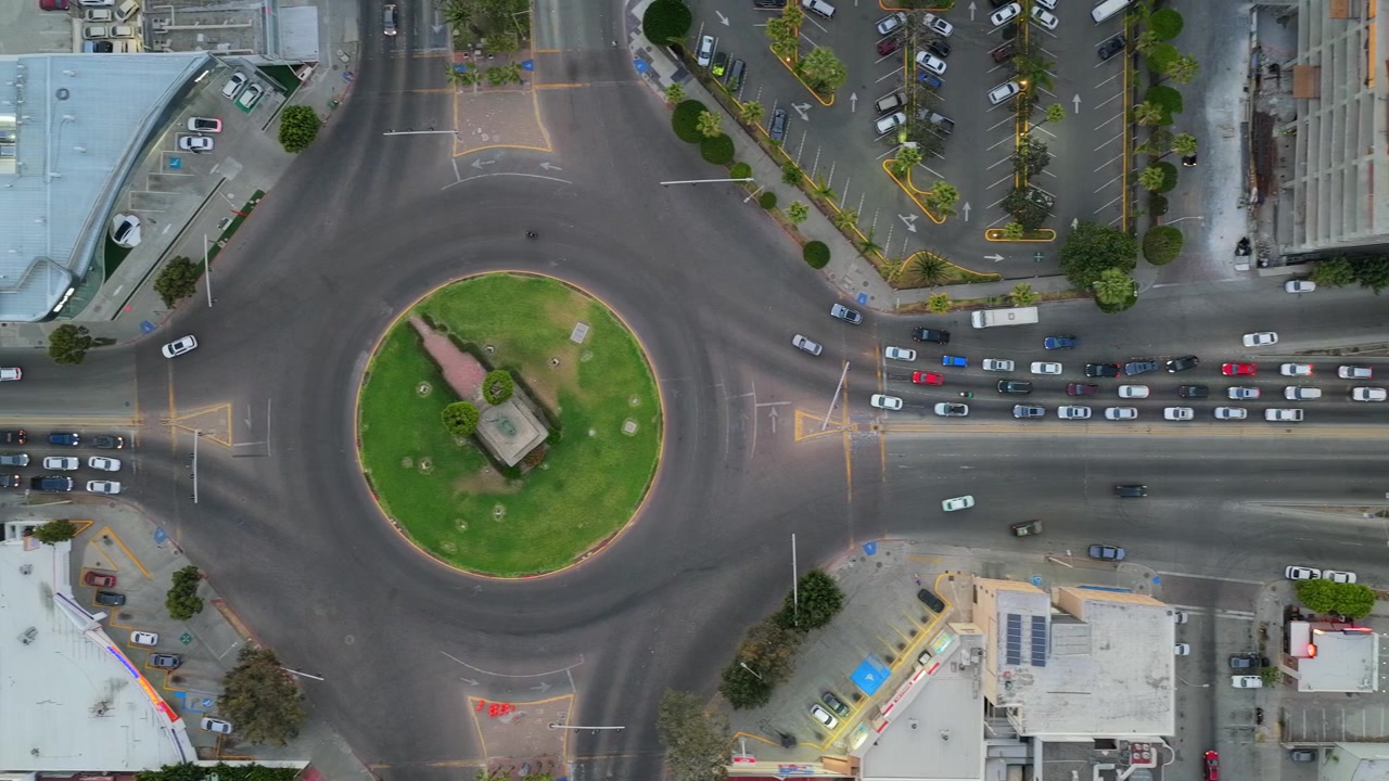 Pan left top down aerial of Independence Boulevard and Monumento México roundabout in downtown Tijuana
