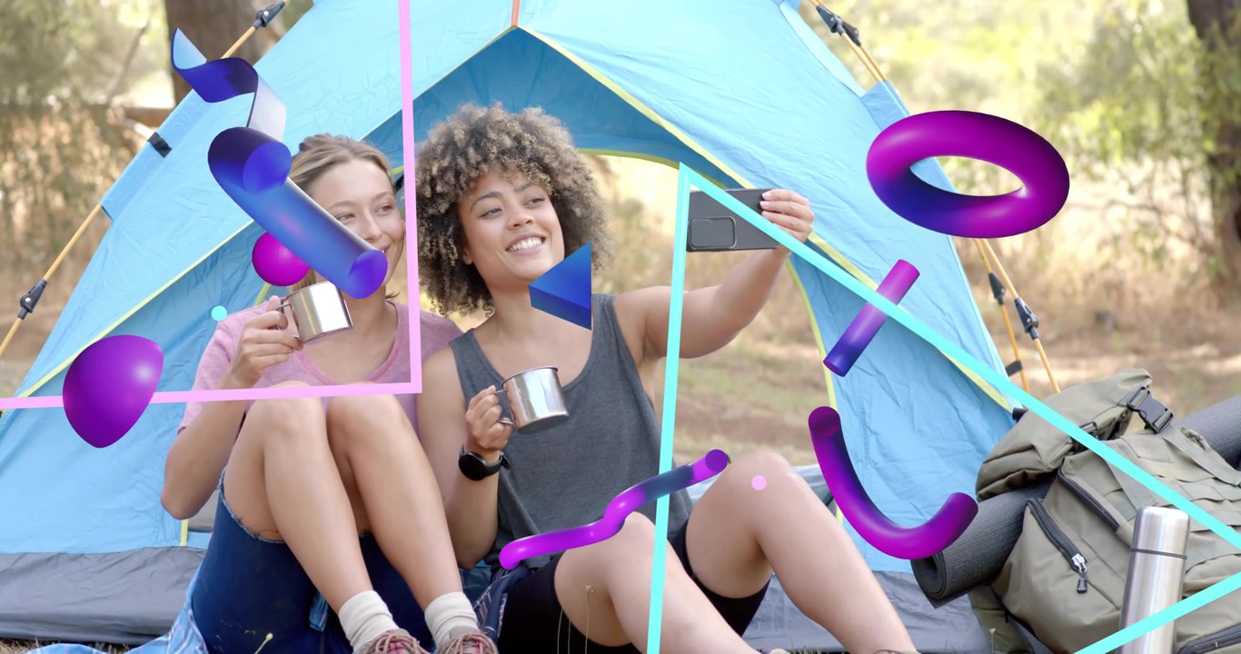 Two women holding mugs at campsite one lifting smartphone framing selfie amid abstract tent shapes