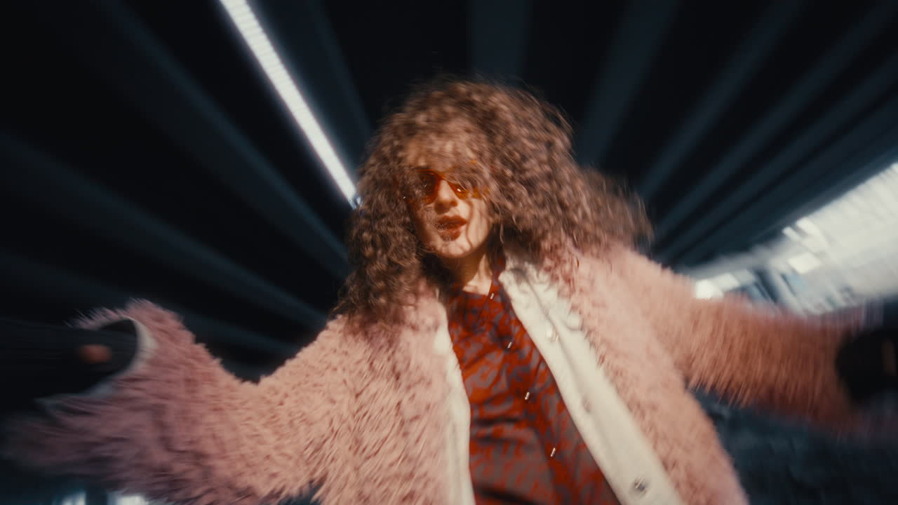 Stylish Young Woman in Trendy Outfit Dancing under Urban Bridge